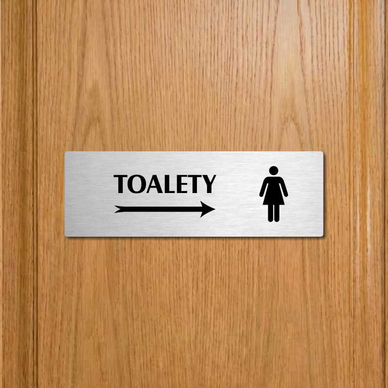 Toalety vpravo ženy, 240x79mm, zlatá popiska s okrasným rámečkem  